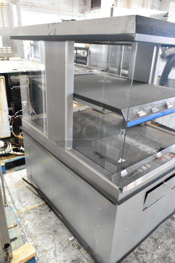 Custom Deli's metal commercial 2-tier warming display merchandiser on casters; features glass panels, sturdy metal frame, and storage capacity.