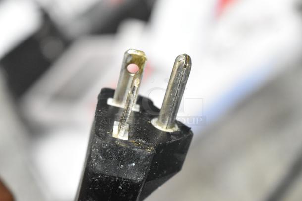 Close-up of an electrical plug from the Avantco 17IC3500 induction range, suitable for 208-240 volts, single-phase.
