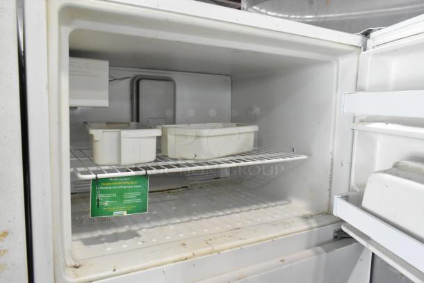 Maytag M1TXEGMYW00 metal reach-in cooler with freezer, 115V, 1 phase. Interior shows shelves, slight wear.