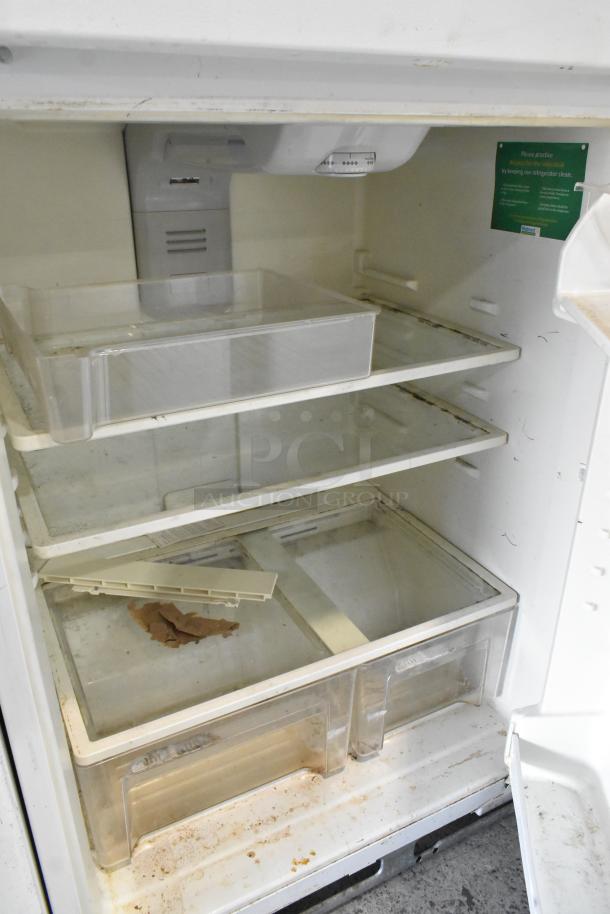 Maytag M1TXEGMYW00 metal reach-in cooler with freezer, 115V, 1 phase. Interior shelves visible, shows wear and stains.