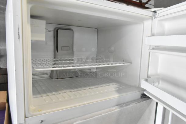 Maytag M1TXEGMYW00 metal reach-in cooler with freezer, 115 volts, 1 phase, white interior, single metal shelf, good condition.
