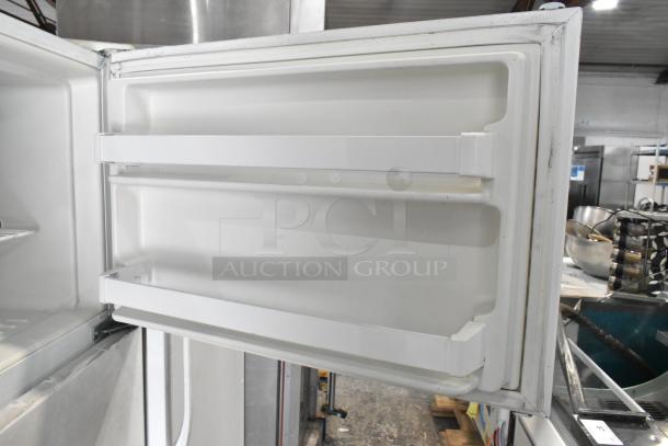Maytag M1TXEGMYW00 metal reach-in cooler with freezer, interior door view, clean condition, 115 volts, 1 phase.