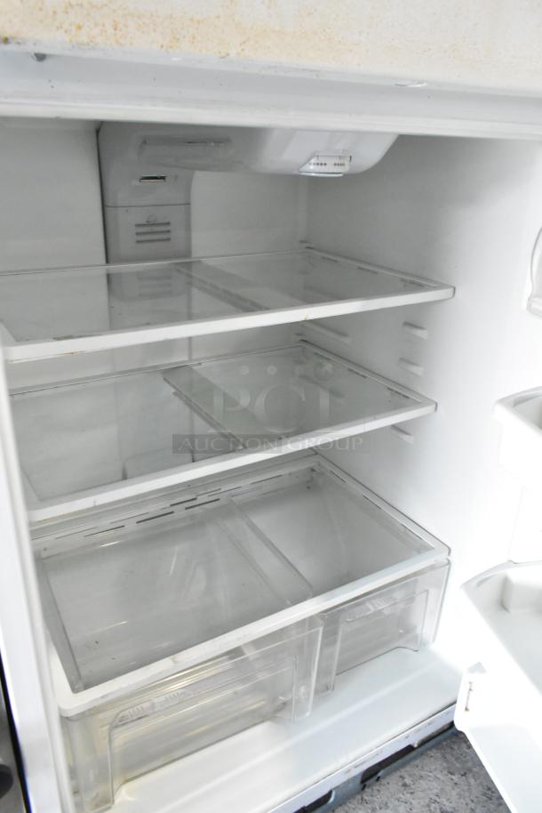 Maytag M1TXEGMYW00 metal reach-in cooler with freezer, 115 volts, 1 phase. Interior view showing intact shelves and bins.