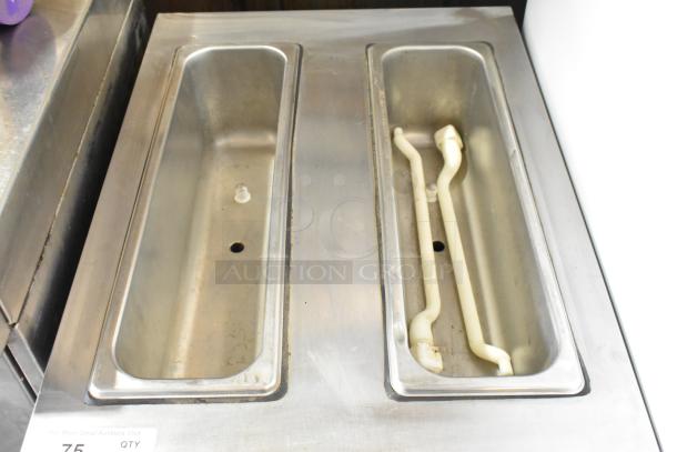 SaniServ A7581E stainless steel 2-flavor frozen beverage machine with dual compartments. Model A7581E, 115V, used condition.