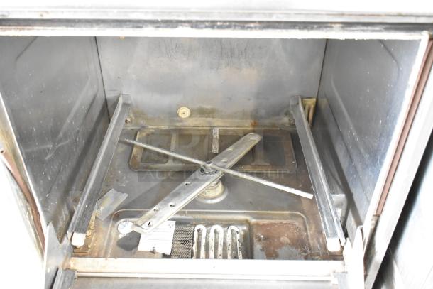 Hobart LXIH stainless steel commercial dishwasher interior, visible spray arm, signs of wear, 120/208-240V, 1 phase.