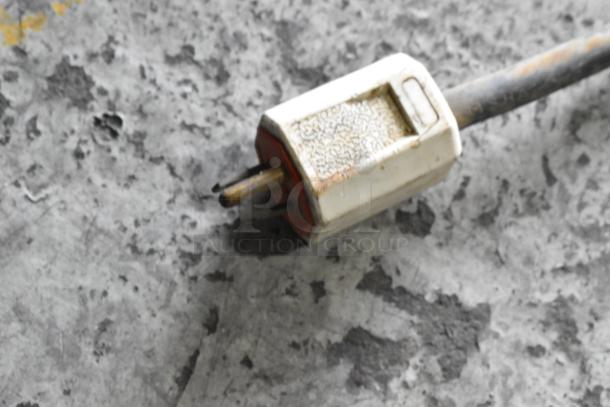 Close-up of an electrical plug on a SaniServ A4071-E ice cream machine. Plug shows signs of wear.