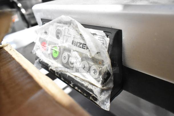Bizerba metal commercial countertop meat slicer control panel; worn condition, with visible buttons and brand label.