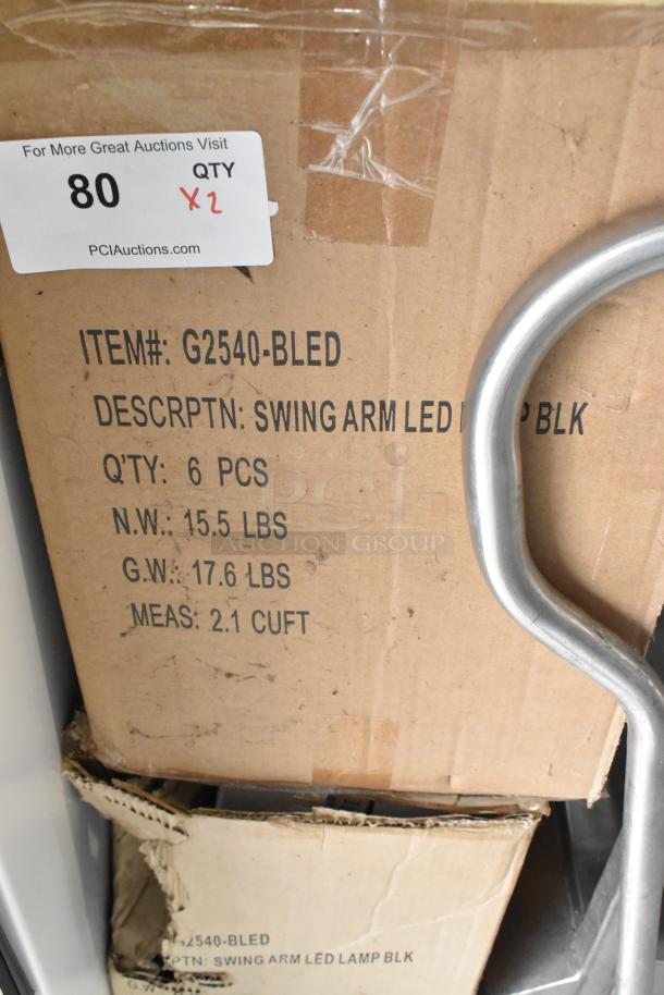 Two boxes of new G2540-BLED Swing Arm LED Lights, each holding 6 pieces. Boxes labeled with weight and dimensions.