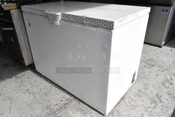Whirlpool WZC3115DW00 metal chest freezer in used condition, 115 volts, 1 phase, shows exterior wear, top hatch visible.