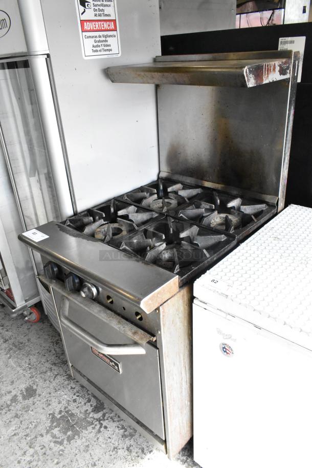 Tri-Star Stainless Steel Commercial 4-Burner Gas Range with oven, over shelf, and backsplash, in used condition.