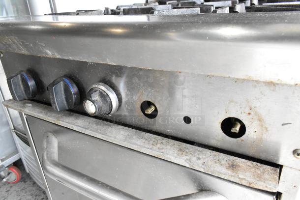 Tri-Star stainless steel commercial gas range, four burners, oven below, over shelf, back splash, used condition.