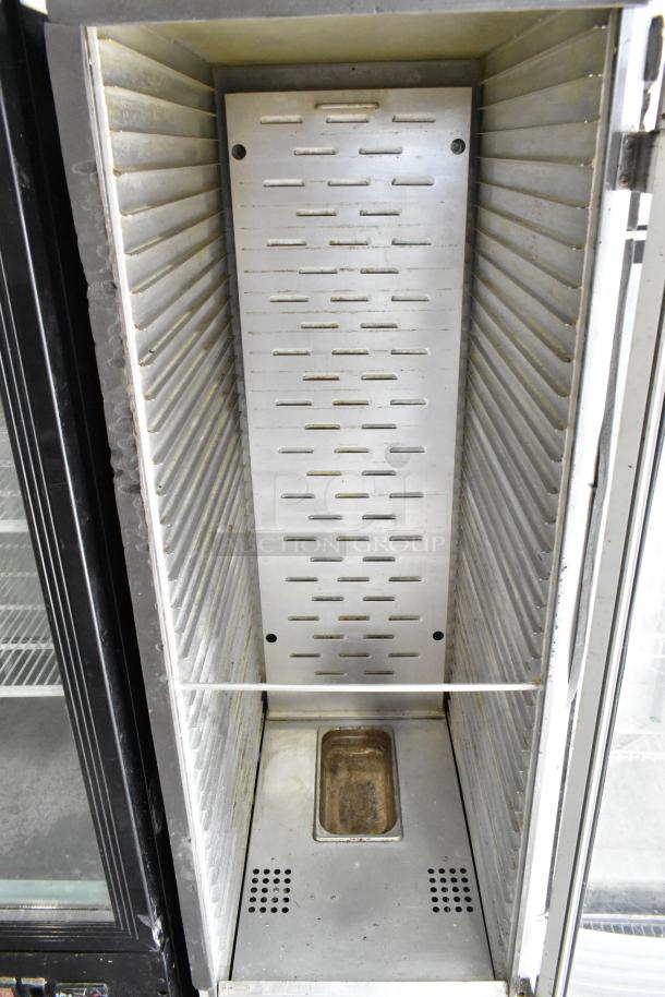 Winholt NHPL-1836CA/LC metal heated holding pan rack, interior view, on casters. Door malfunction noted. 120V, 1 phase.