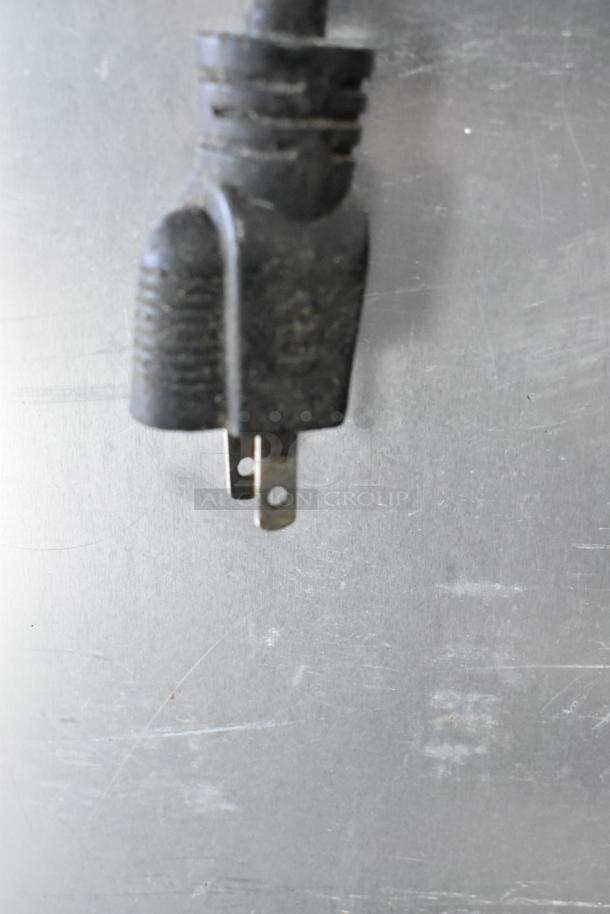 Alt text: Close-up of electrical plug for Winholt NHPL-1836CA/LC heated holding pan rack, 120 volts, 1 phase.