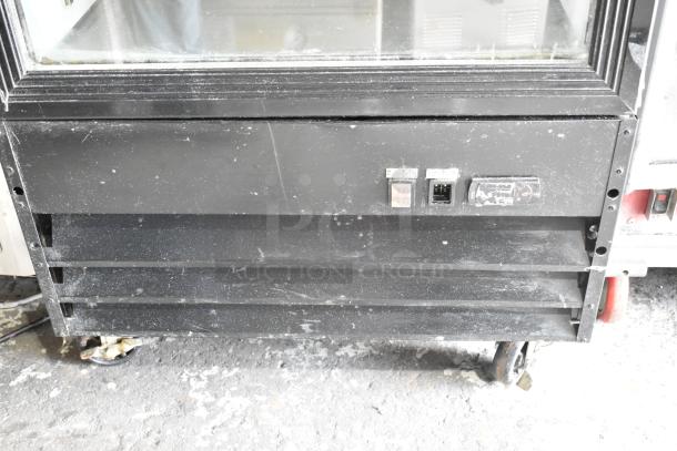 EGDM-29B Single Door Reach-In Cooler with poly coated racks, commercial casters; 115V, 1 Phase; black exterior, light wear.