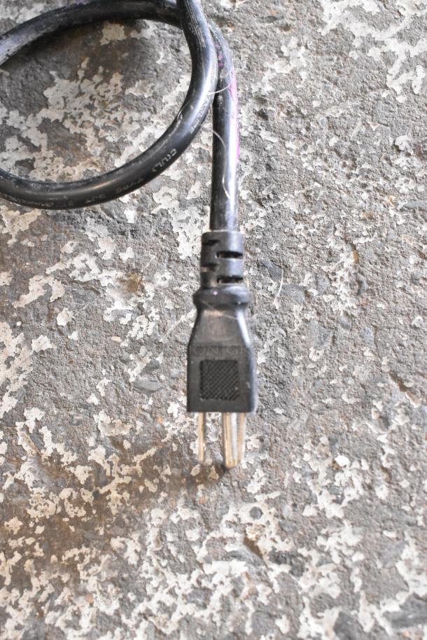 A power plug and cord for the EGDM-29B Reach In Cooler, shown on a textured surface.