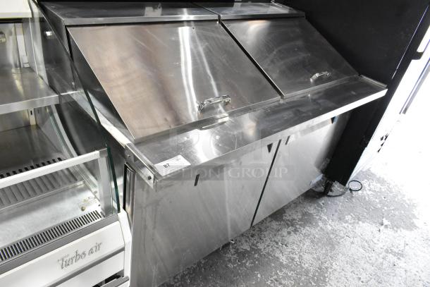 Turbo Air MST-60-24 commercial sandwich prep table in metal, with two top lids, on casters. 115V, 1 Phase, model label visible.
