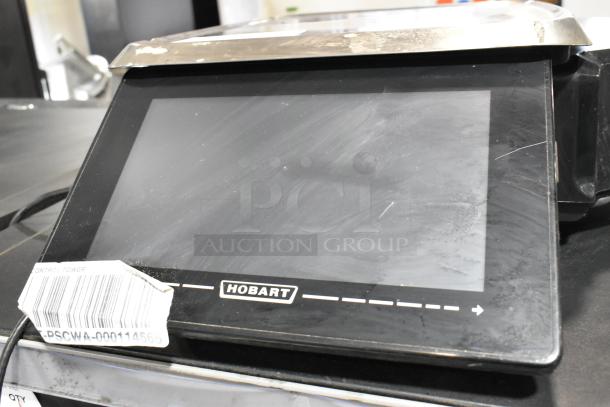 2016 Hobart HTi Metal Commercial Scale, countertop model. Visible Hobart logo, barcode label, slight surface wear.