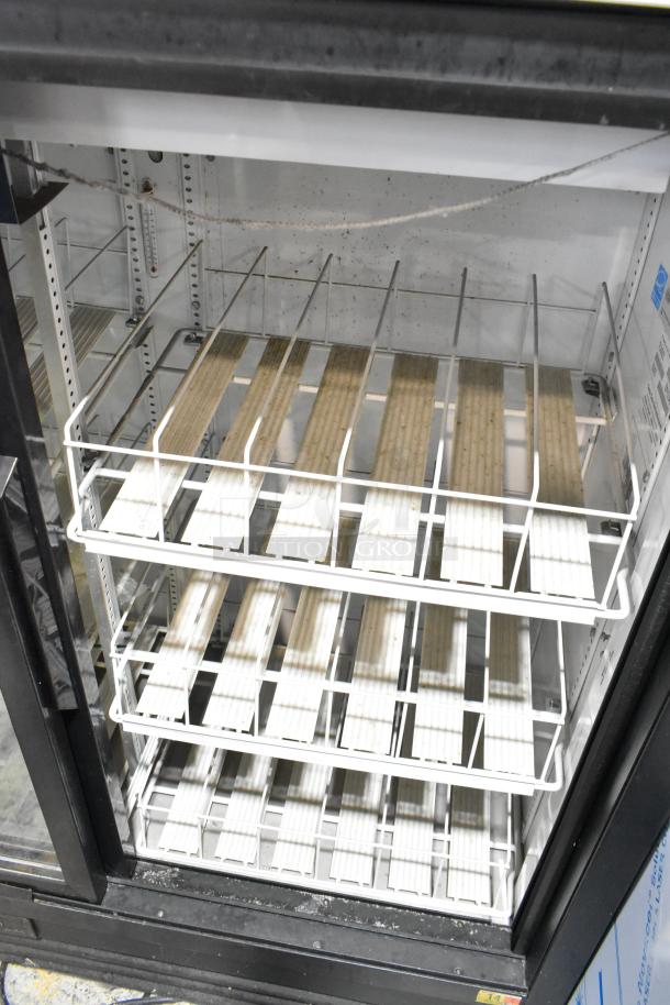 True GDM-41SL-54EM-LD commercial cooler, 2-door reach-in, includes poly-coated racks, 115 volts, visible interior wear.