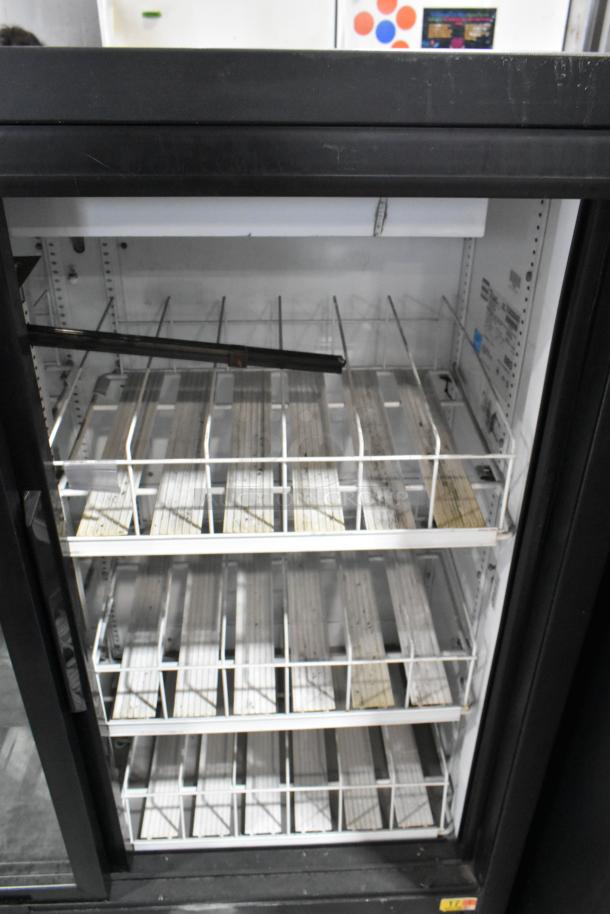 True GDM-41SL-54-LD commercial 2-door cooler merchandiser, poly-coated racks, 115 volts, 1 phase, interior label visible.