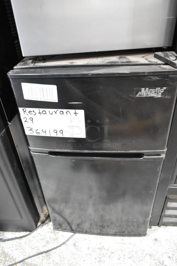 2024 Arctic King ATMP032AEB Mini Cooler with Freezer. Black finish, visible label and barcode, slightly dusty condition.