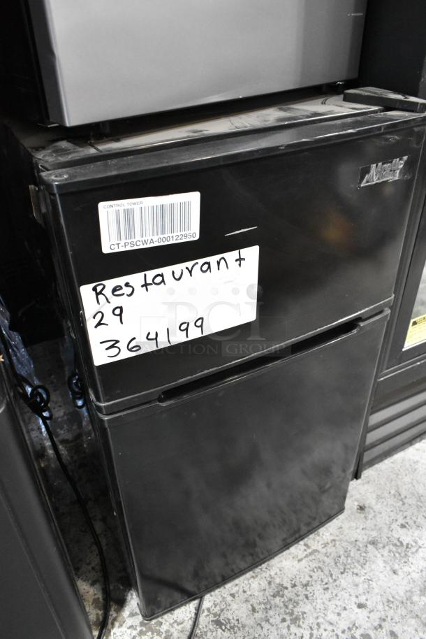 2024 Arctic King ATMP032AEB mini cooler with freezer, black, 115 volts, featuring barcode label and handwritten “Restaurant 29” tag.