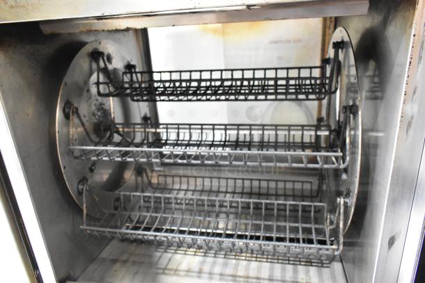 Fri-jado TDR7-P rotisserie oven with stainless steel interior, visible racks, electric-powered, on commercial casters.