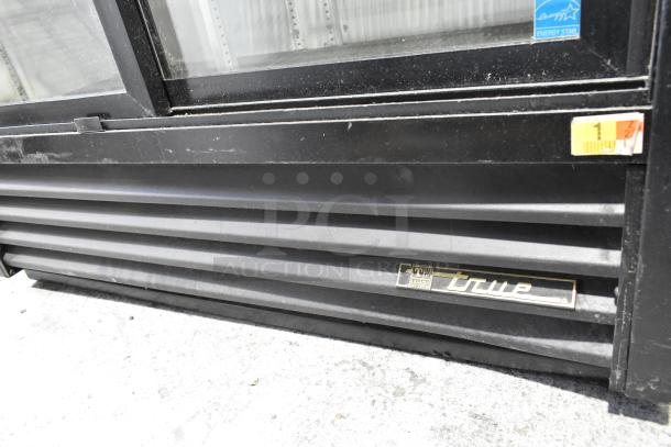 True GDM-41SL-60-LD cooler merchandiser, dual glass doors, metal frame, Energy Star label, visible surface wear.