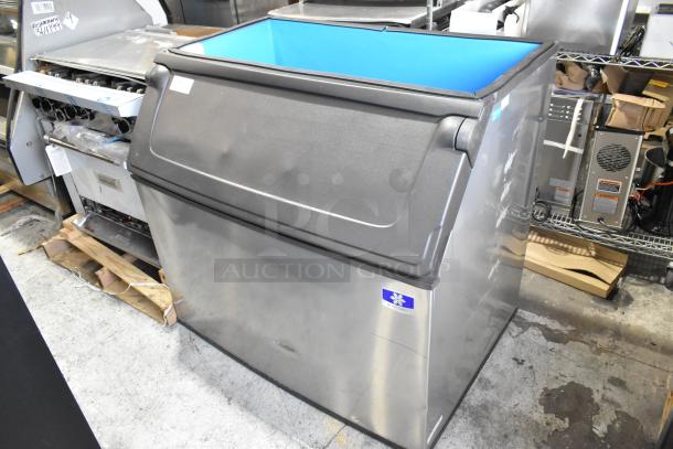 Manitowoc D970 stainless steel ice bin, 48-inch, holds 882 lbs. Features stainless finish, front-opening lid, and blue interior.