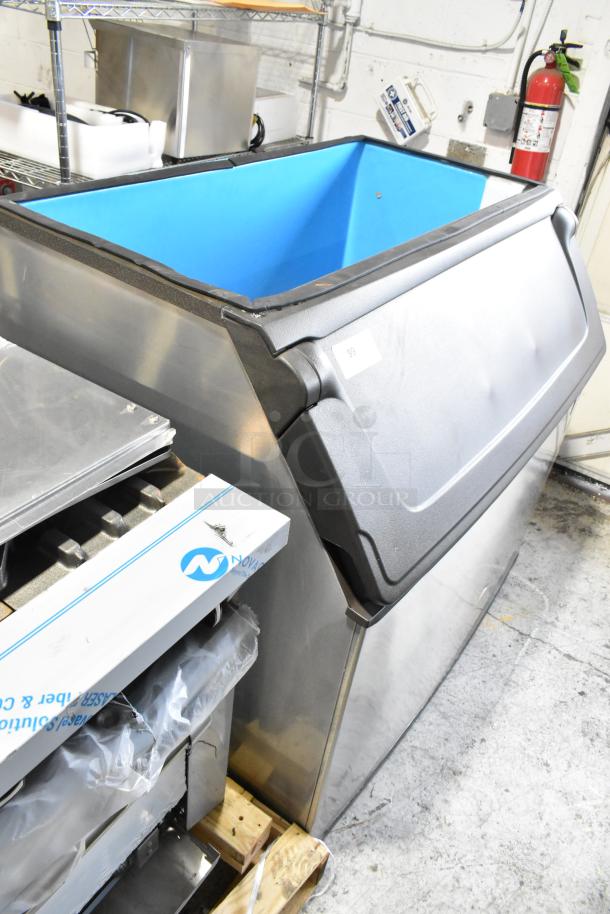 Manitowoc D970 stainless steel commercial ice bin, 48" width, 882 lbs capacity, in good condition, blue interior.