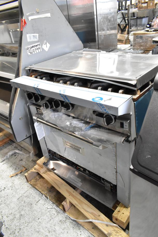Brand new Garland 372G366CN stainless steel 6-burner range with convection oven and overshelf. Scratch and dent condition.