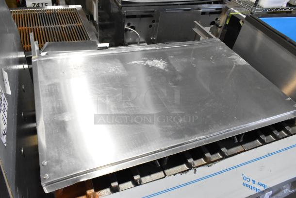Brand new Garland 372G366CN commercial range, 6 burners, convection oven, over shelf, 236,000 BTU, stainless steel. Minor scratches.