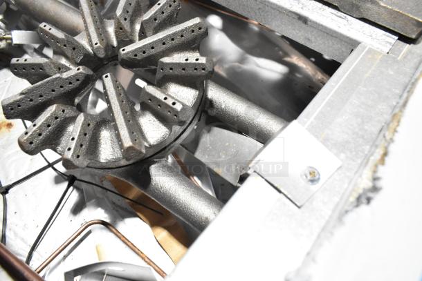 Close-up of a Garland 372G366CN stainless steel burner component, showing gas outlets for a commercial range.