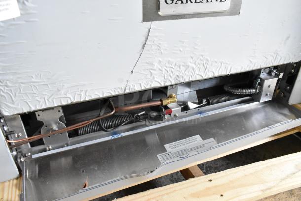 Garland 372G366CN stainless steel commercial range with 6 burners, convection oven, overshelf, 236,000 BTU. Minor dents visible.