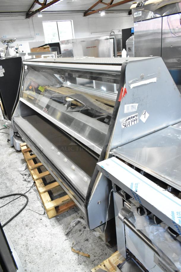 Custom Deli's metal commercial warming display case, floor style. Features sliding glass doors, stainless steel shelves, minor wear.