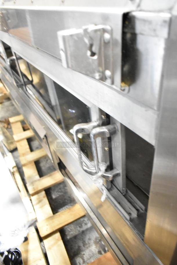 Custom Deli's metal commercial floor-style warming display case in good condition, featuring sturdy handles and shiny finish.