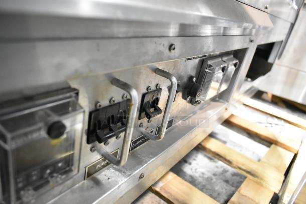 Custom Deli's Metal Commercial Floor Style Warming Display Case; controls and switches visible; robust metal finish.
