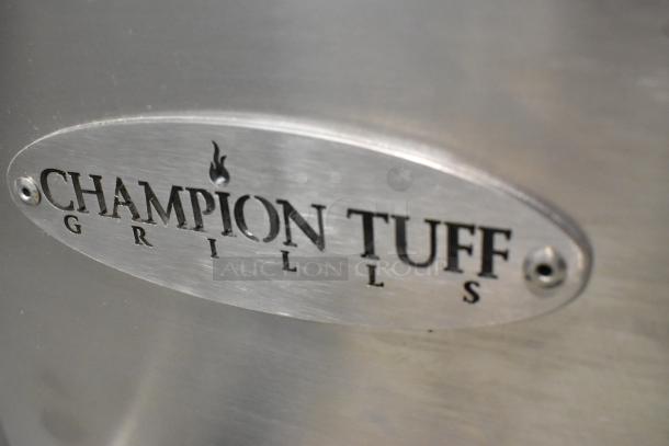 Champion Tuff 782TG60 stainless steel 60" wood-burning grill nameplate, showcasing brand logo.