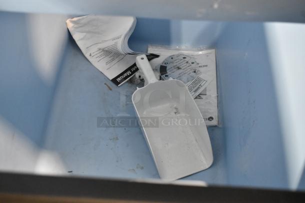 Avantco 194BIN40022 ice storage bin interior with white scoop and manual. Capacity: 383 lbs, metallic alloy exterior. Brand new, scratch and dent.