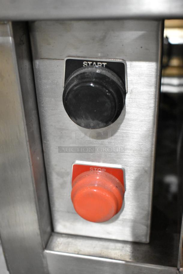 Start and stop buttons on Champion Tuff 782TG60 stainless steel grill, showing control panel details.