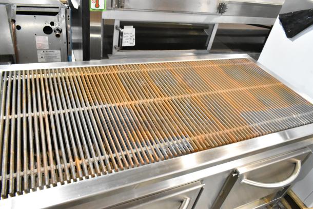 Champion Tuff 782TG60, 60" stainless steel wood-burning grill, scratch and dent, new condition, visible texture and components.