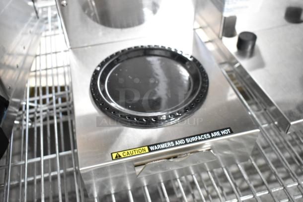 Stainless steel Bunn Single Axiom 15 coffee machine with hot water dispenser, brew basket, and caution label. 120V, brand new with minor dents.