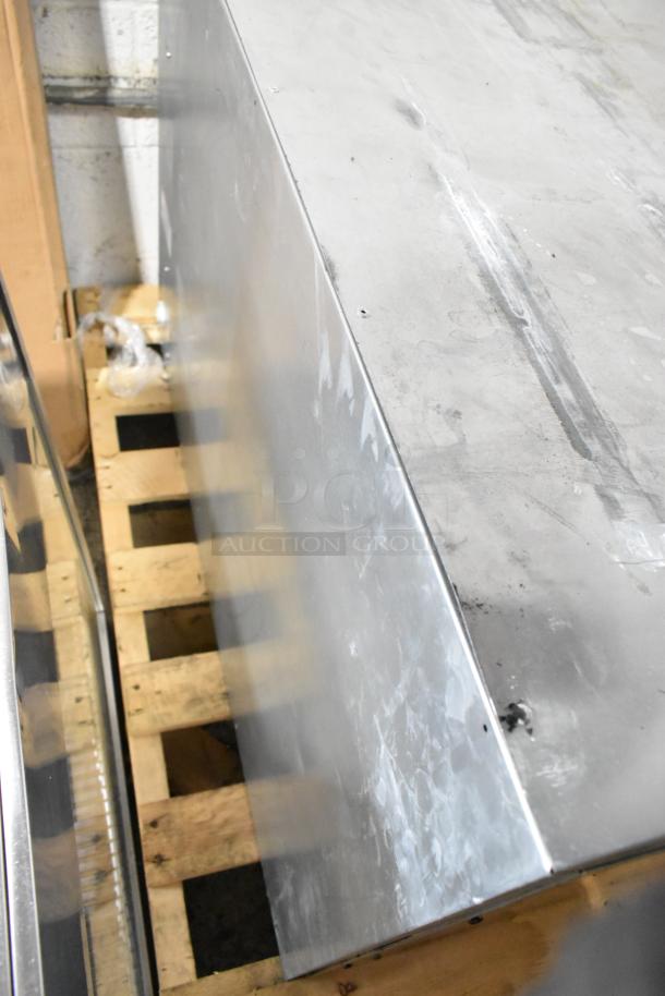 Trento stainless steel commercial pizza oven, brand new, with scratches and dents, on a wooden pallet.