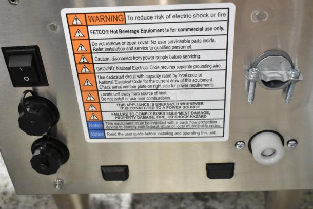 Stainless steel Fetco CBS-2251 coffee brewer with safety warnings and switch details. 208-240V, 1 Phase, pre-owned condition.