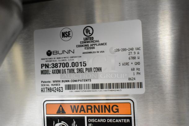 Stainless steel tag on Bunn AXIOM 0/6 TWIN coffee brewer, showing model, serial number, power info, and safety warning.