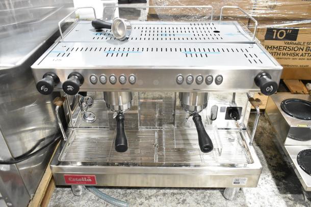 Brand new Estella ECEM2 stainless steel commercial espresso machine, two-group, 2 portafilters, 2 steam wands, minor dent.