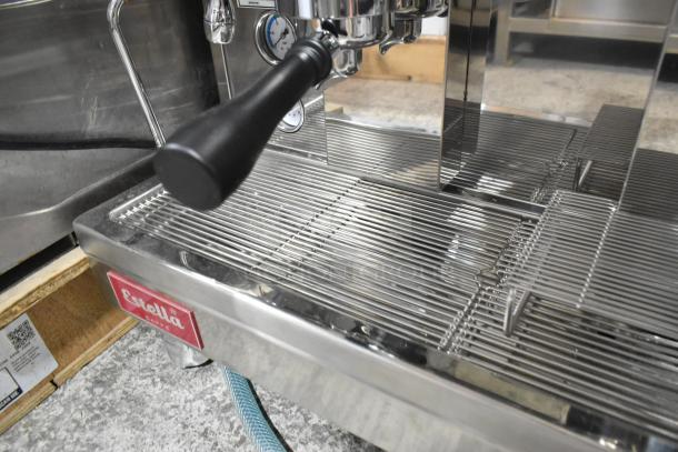 Estella ECEM2 two-group espresso machine, stainless steel, with portafilter and steam wand. One leg defective.