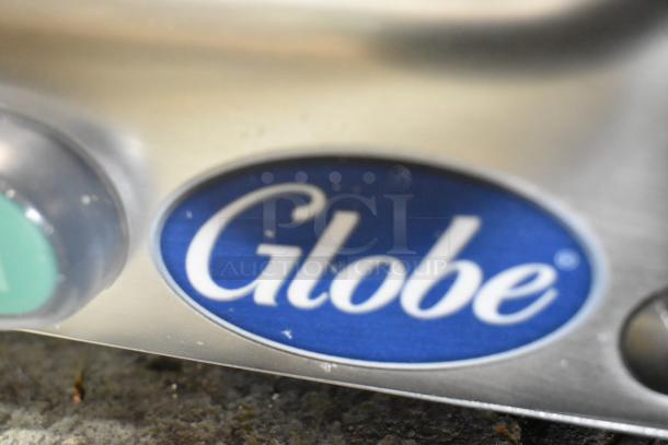 Globe G10 slicer logo detail view. Features include 10" manual gravity feed, blade sharpener, 1/3 hp, 115V, 1 phase. Brand new.