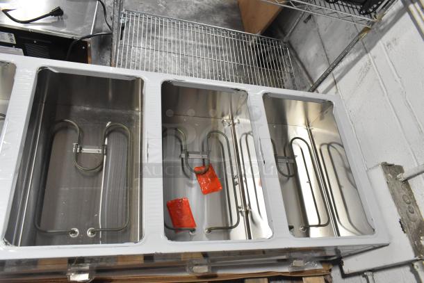 Brand new ServIt 423EST5WOPB five-pan open well electric steam table with angled sneeze guard. Scratch and dent condition.