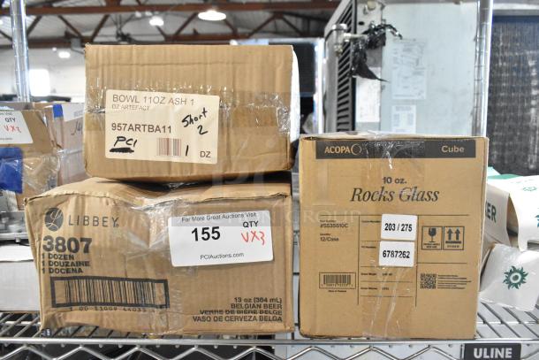 Three boxes of new items: Front of the House porcelain bowls, Libbey beer glasses, and Acopa rocks glasses, packaged and labeled.