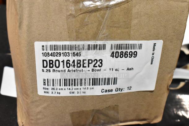 Label on cardboard box reading "DBO164BEP23 5.25 Round Artefact Bowl 11 oz. Ash" with size and weight details.